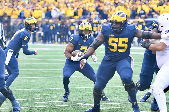 J.J. McCarthy (9), Donovan Edwards (7), and Olusegun Oluwatimi (55)