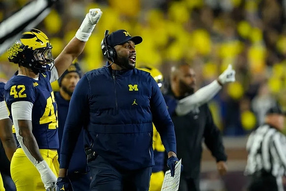 TJ Guy (42) and Sherrone Moore