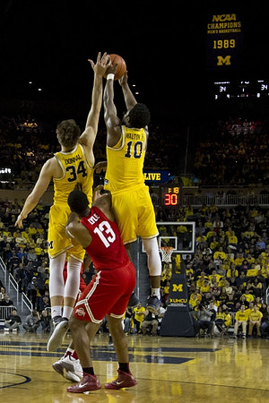 Mark Donnal (34) and Derrick Walton Jr. (10)
