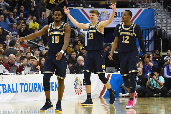 Derrick Walton Jr. (10), Moritz Wagner (13), and Muhammad-Ali Abdur-Rahkman (12)