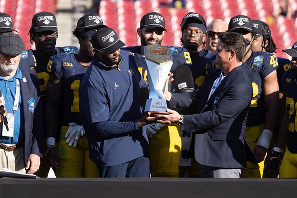 Sherrone Moore, Michigan Team, and ReliaQuest Bowl Trophy