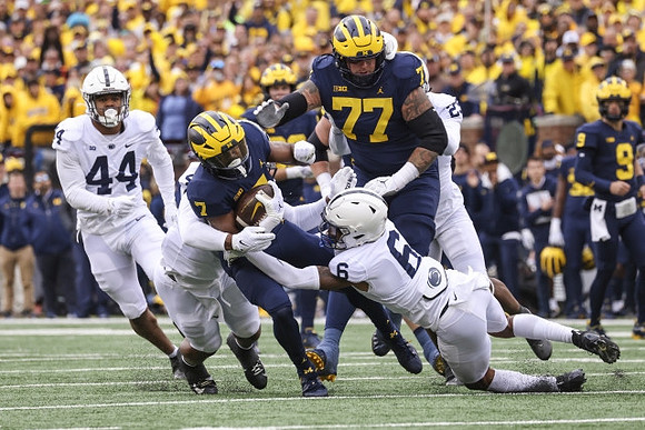 Donovan Edwards (7), Trevor Keegan (77), and J.J. McCarthy (9)