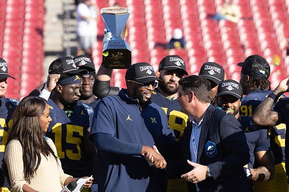 Sherrone Moore, Michigan Team, and ReliaQuest Bowl Trophy