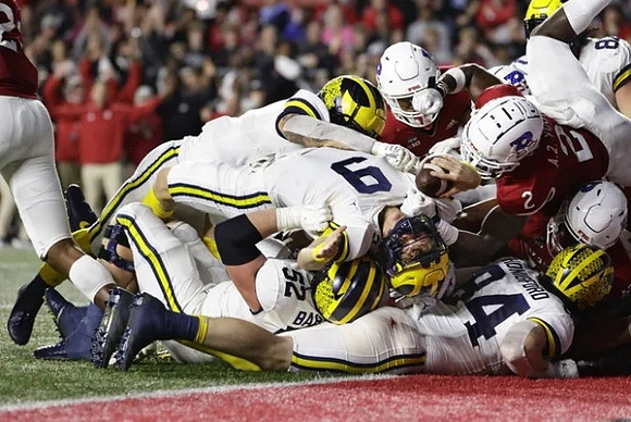 Karsen Barnhart (52), J.J. McCarthy (9), and Joel Honigford (84)