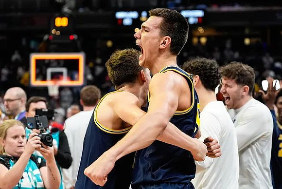 Will Tschetter (42), Vladislav Goldin (50), and Michigan Team