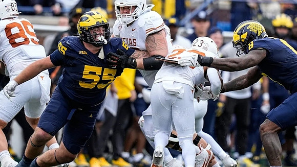 Mason Graham (55) and Derrick Moore (8)