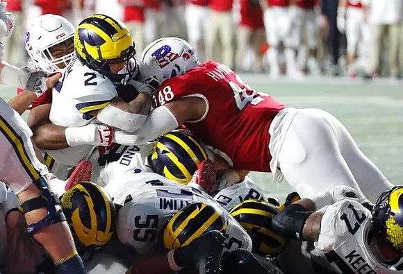 Blake Corum (2), Giovanni El-Hadi (58), Olusegun Oluwatimi (55), Colston Loveland (18), and Trevor Keegan (77)