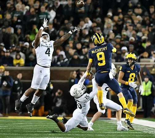 J.J. McCarthy (9) and Ronnie Bell (8)