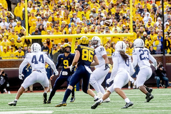 J.J. McCarthy (9) and Luke Schoonmaker (86)
