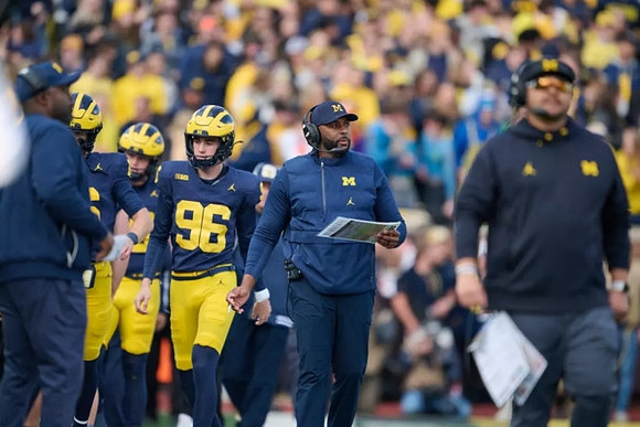 Dominic Zvada (96) and Sherrone Moore