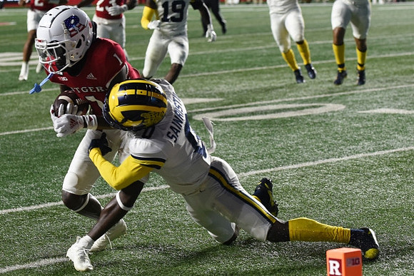 Mike Sainristil (0) and Rod Moore (19)