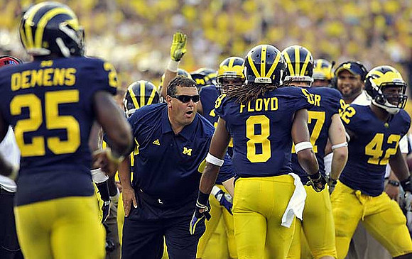 Kenny Demens (25), Brady Hoke, J.T. Floyd (8), Brennen Beyer (97), and J.B. Fitzgerald (42)