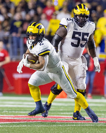 Blake Corum (2) and Olusegun Oluwatimi (55)