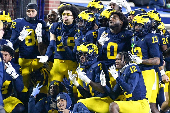 Mason Curtis (25) and Michigan Team