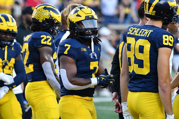 Tavierre Dunlap (22), Donovan Edwards (7), and Kaleb Schlecht (89)