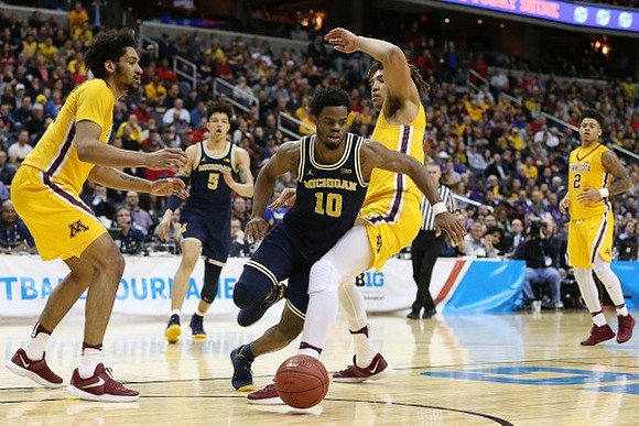 D.J. Wilson (5) and Derrick Walton Jr. (10)
