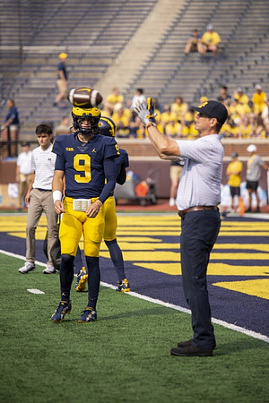 J.J. McCarthy (9) and Jim Harbaugh