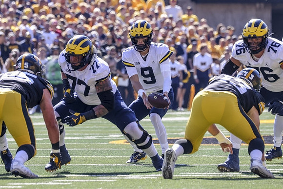 Trevor Keegan (77), J.J. McCarthy (9), and Ryan Hayes (76)