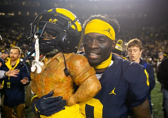 Paul Bunyan Trophy and Mike Sainristil (0)