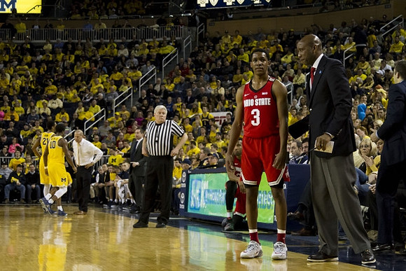 Zak Irvin (21), Derrick Walton Jr. (10), and John Beilein