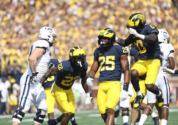 Gemon Green (22), Junior Colson (25), and Mike Sainristil (0)