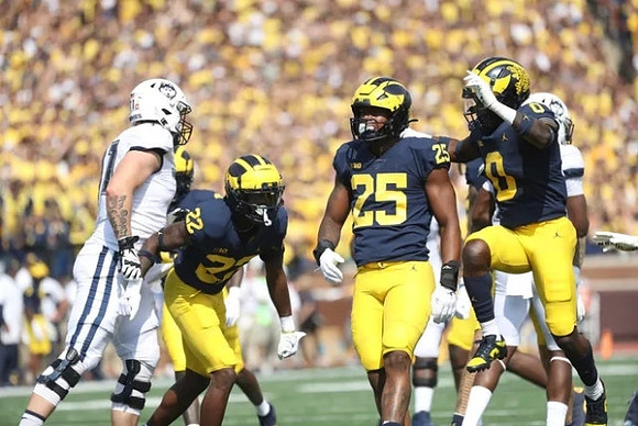 Gemon Green (22), Junior Colson (25), and Mike Sainristil (0)