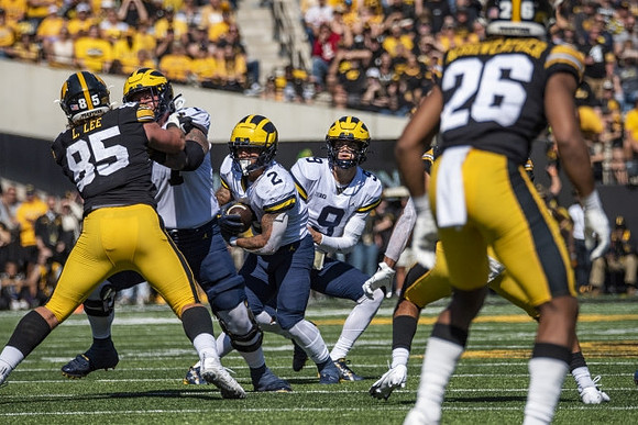 Zak Zinter (65), Blake Corum (2), and J.J. McCarthy (9)