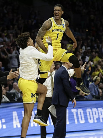 Jordan Poole (2), Charles Matthews (1), John Beilein, and Luke Yaklich