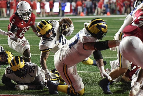 Olusegun Oluwatimi (55), Blake Corum (2), and Trevor Keegan (77)