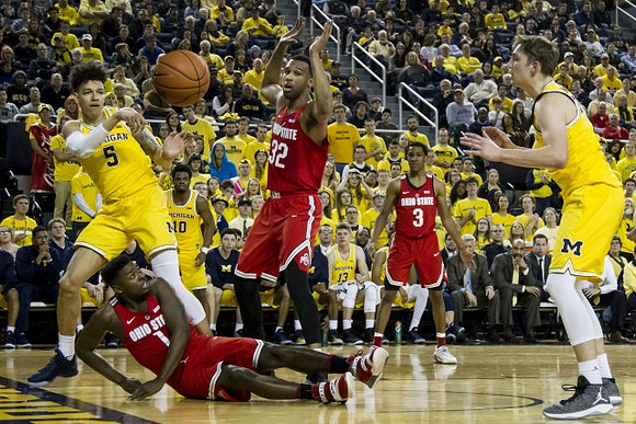 D.J. Wilson (5), Derrick Walton Jr. (10), and Mark Donnal (34)