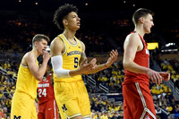 Moritz Wagner (13) and D.J. Wilson (5)