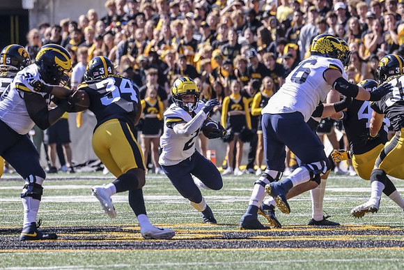 Olusegun Oluwatimi (55), Blake Corum (2), and Ryan Hayes (76)