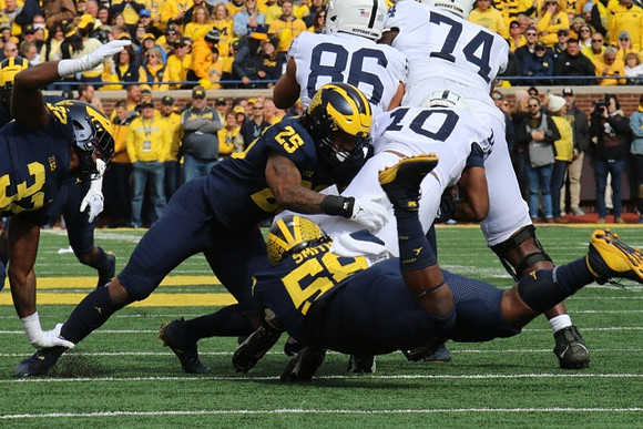 Jaylen Harrell (32), Junior Colson (25), and Mazi Smith (58)