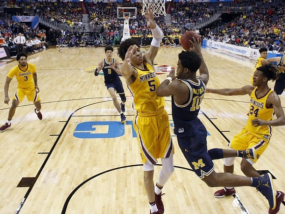 D.J. Wilson (5) and Derrick Walton Jr. (10)