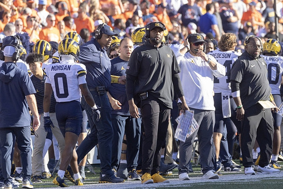 Semaj Morgan (0), Sherrone Moore, and Michigan Team