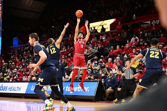Hunter Dickinson (1), DeVante' Jones (12), and Caleb Houstan (22)
