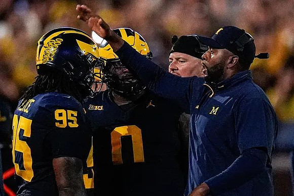 Trey Pierce (95), Tré Williams (0), Lou Esposito, and Sherrone Moore