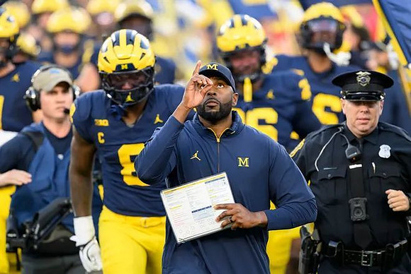 Derrick Moore (8), Sherrone Moore, and Michigan Team