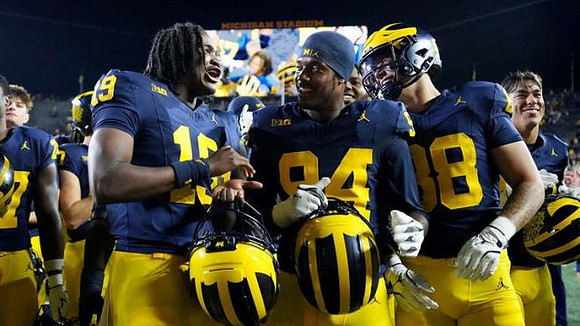 Bryce Underwood (19), Nate Marshall (94), and Deakon Tonielli (88)