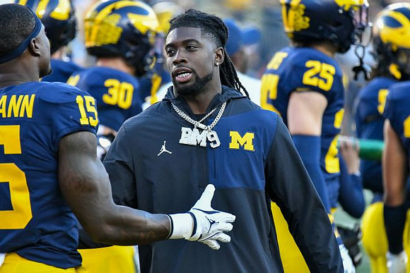 Rod Moore (19) and Michigan Team