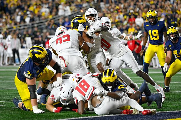 Evan Link (71), Jalen Hoffman (42), Bryce Underwood (19), and Max Bredeson (44)