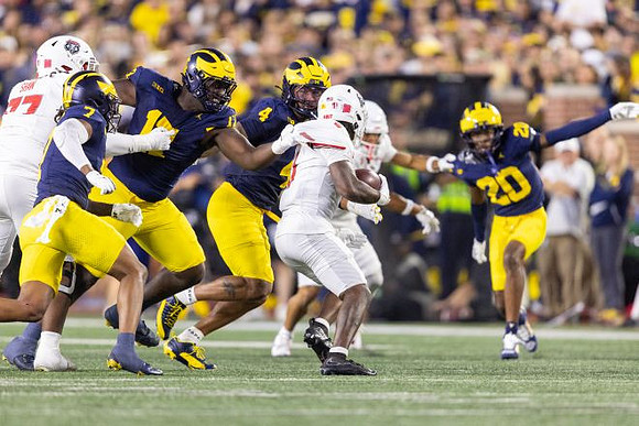 TJ Metcalf (7), TJ Guy (4), and Jyaire Hill (20)