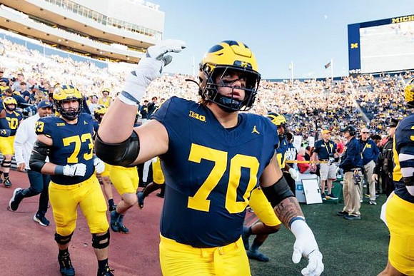 Ben Roebuck (73), Brady Norton (70), and Michigan Team