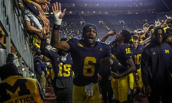 Brandyn Hillman (6) and Michigan Team