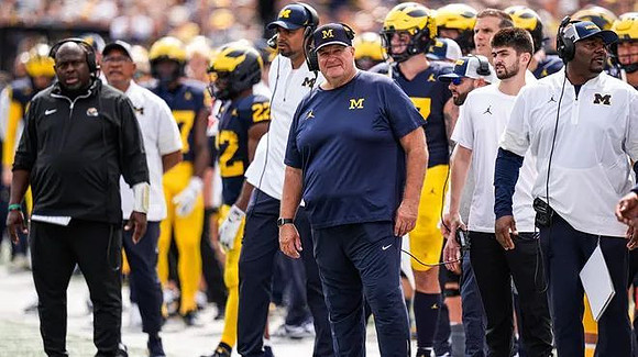 Acting Head Coach Biff Poggi and Michigan Team