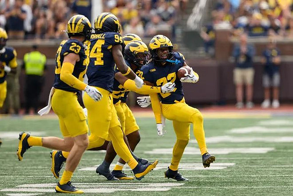 Cole Sullivan (23), Nate Marshall (94), Jyaire Hill (20), and Elijah Dotson (22)