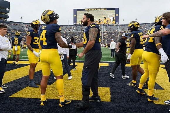 Giovanni El-Hadi (58), TJ Guy (4), and Michigan Team