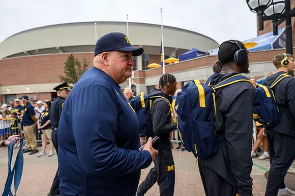 Acting Head Coach Biff Poggi and Michigan Team