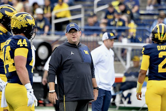 Max Bredeson (44), Jadyn Davis (2), and Michigan Team