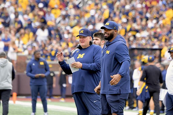 Acting Head Coach Biff Poggi and Michigan Team